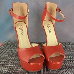 Red ankle strap w/ buckle, 5" peep-toe platform stiletto heels.